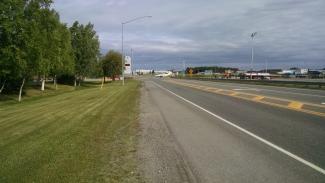 A small aircraft taxiing across a street at the Anchorage airport as I walked up to Everts