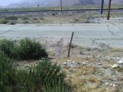 The cut fence to the frontage road